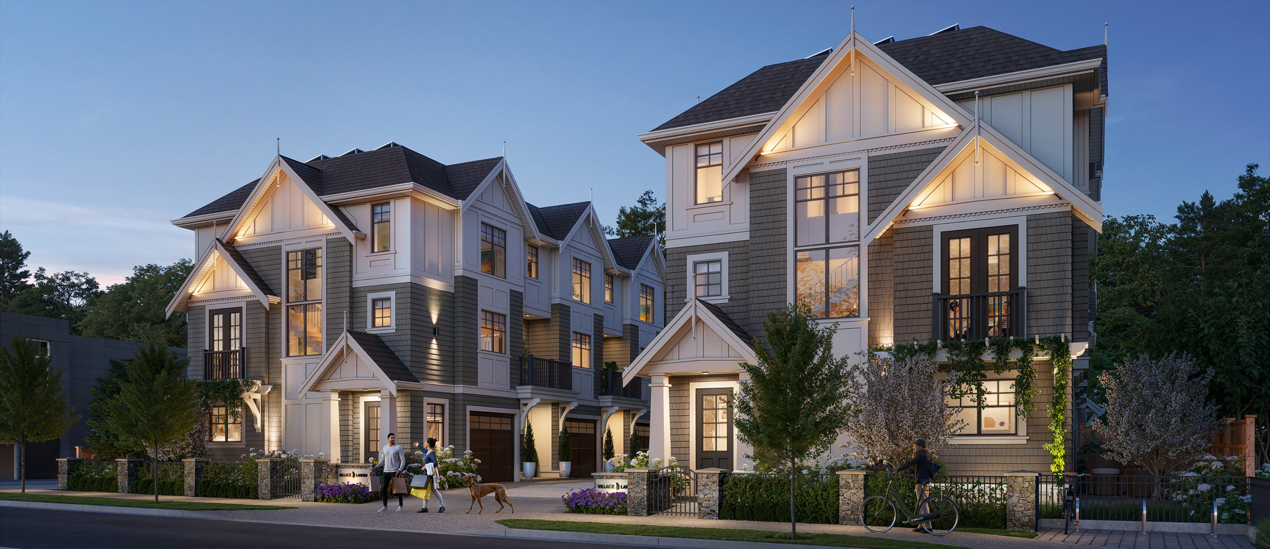 Evening rendering of Village Landing townhomes with warm exterior lighting and landscaped pathways.