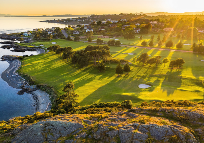 Victoria Royal Gold Course with greens and ocean at sunset.