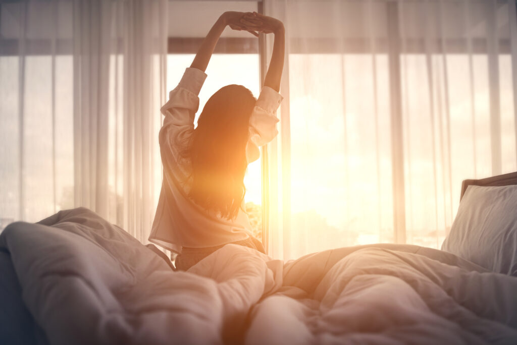 Woman stretching with sunlight